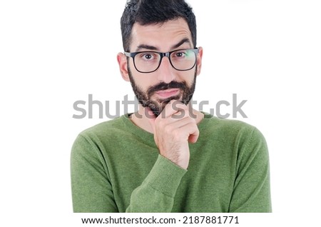 Bearded man with an expression of discontent on his face. Young man wearing casual clothes skeptic and nervous, disapproving expression on face, negative person. Isolated on white background