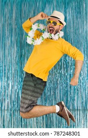 Bearded Man In Green And Yellow Clothes, Sunglasses And Hawaiian Necklace. Carnival Of Brazil, Eve Of Year End, Euphoria And Fun. Colorful And Bright Background.