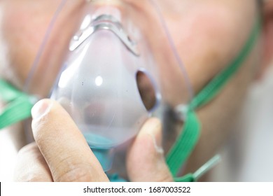 The Bearded Man Has An Oxygen Mask On His Face. Close-up. The Patient Has Trouble Breathing.