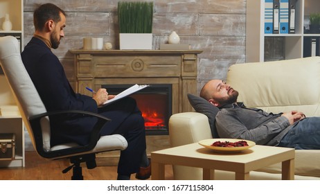 Bearded Man Laying Down On Couch At Couple Therapy Talking About His Relationship Conflicts With His Wife.