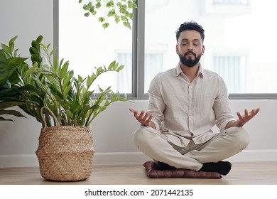 Bearded Man In Linen Pants And Shirt Meditating In Lotus Position Trying To Relax After Stressful Day