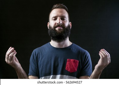 Bearded Man Meditating, Open Eyes, Isolated On Black Background