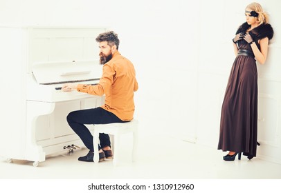 Bearded man in mustard yellow shirt playing piano while pretty girl in twenties dress and fur collar leaning on wall isolated on white background. - Powered by Shutterstock