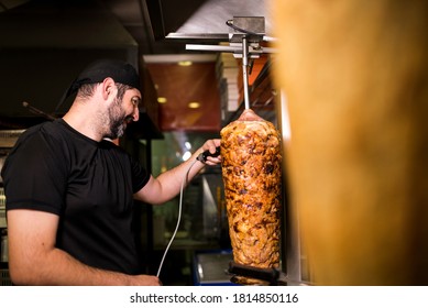 Bearded Man Preparing Kebab Meat In Pizza Bar.