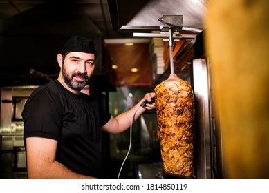 Bearded Man Preparing Kebab Meat In Pizza Bar.