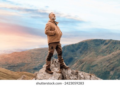 Bearded Man reaching the destination  and on the top of mountain  at sunset on autumn day  Travel  Lifestyle concept The national park Lake District in England