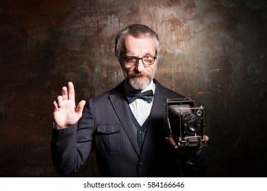 Bearded man with retro camera