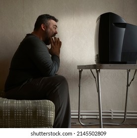 Bearded Man Screaming In Shock While Watching Retro Aged Tv Alone.  One Male Sitting On Sofa In Old  Living Room. Sports Fan. Shock News.