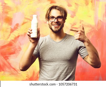 Bearded Man, Short Beard. Caucasian Sexy Happy Smilling Macho With Moustache In Glasses Wearing Gray Shirt Holding Plastic Bottle Of Milk On Colorful Studio Background