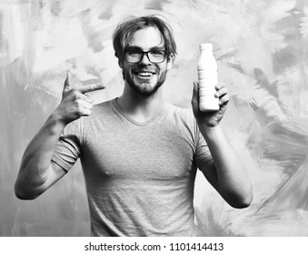 Bearded Man, Short Beard. Caucasian Sexy Happy Smilling Macho With Moustache In Glasses Wearing Gray Shirt Holding Plastic Bottle Of Milk On Colorful Studio Background