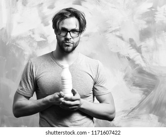 Bearded Man, Short Beard. Caucasian Sexy Serious Macho With Moustache In Glasses Wearing Gray Shirt Holding Plastic Bottle Of Milk On Colorful Studio Background