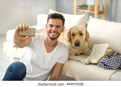 Bearded Man Showing His Dog A Phone