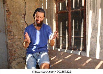 Bearded man sitting and gesticulating