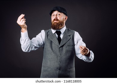 A Bearded Man In Suit Talking And Gesticulating Like Italian On Black Background