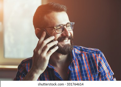 Bearded Man Talking On Phone And Smiling