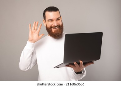 Bearded Man Is Talking Over Video Cam From Laptop And Saying Hi.