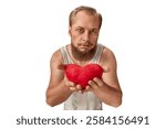 A bearded man in a tank top offers a red plush heart with a serious, heartfelt expression. His intense gaze conveys deep emotions, love, and sincerity. Valentine