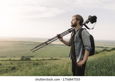 Bearded man using professional equipment for shooting nature