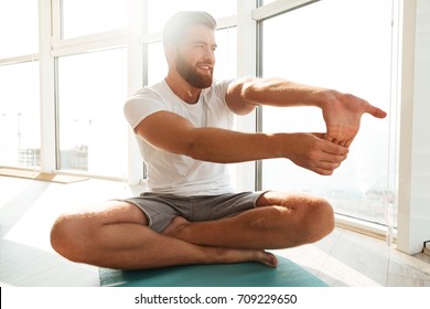 Bearded Man Warming Up Near The Window At Home