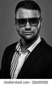 Bearded Man Wearing Sunglasses In A Suit