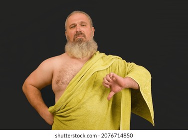 Bearded Man Wearing Towel Like Greek God And Showing Thumb Down On Black Background