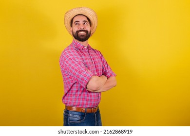 Bearded man wearing typical clothes for party Junina. Arms crossed, smiling, optimistic. - Shutterstock ID 2162868919