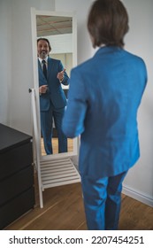 Bearded Mature Man Getting Dressed At The Mirror