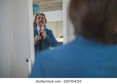 Bearded Mature Man Getting Dressed At The Mirror