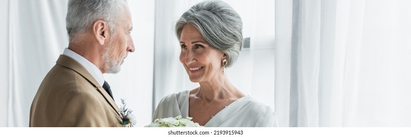 Bearded Middle Aged Groom Looking At Happy Bride In White Dress, Banner