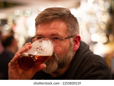 Bearded Middle Aged Man Drinking Pint of Beer. - Powered by Shutterstock