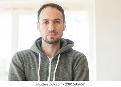 Bearded middle-aged man looking at camera with a serious expression in a close up head and shoulders portrait - Powered by Shutterstock