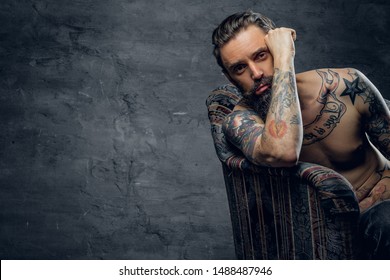 Bearded sad man is sitting in old armchair at abandoned house alone and thinking about his life. - Shutterstock ID 1488487946
