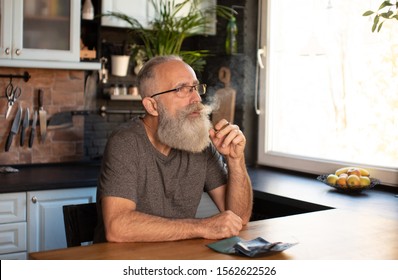 Bearded Senior Man Smoking Marijuana (weed, Cannabis) At Home.