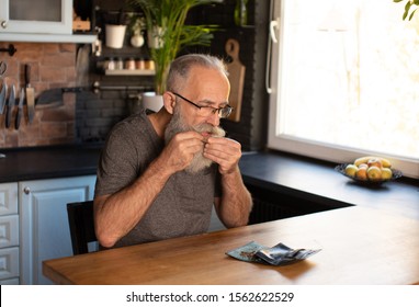 Bearded Senior Man Smoking Marijuana (weed, Cannabis) At Home.