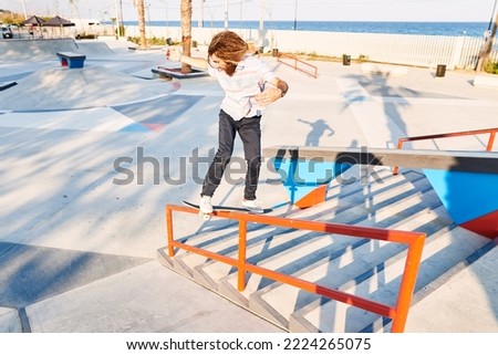 Similar – Image, Stock Photo Young bearded skater performing trick in skatepark