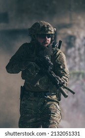 A bearded soldier in uniform of special forces in a dangerous military action in a dangerous enemy area. Selective focus 