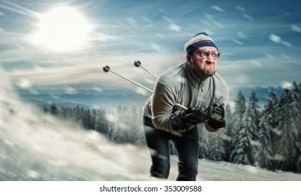 Bearded Vintage Skier In Glasses Skiing Fast While Snowing