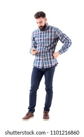 Bearded young Caucasian adult man typing message on mobile phone. Full body isolate on white background.