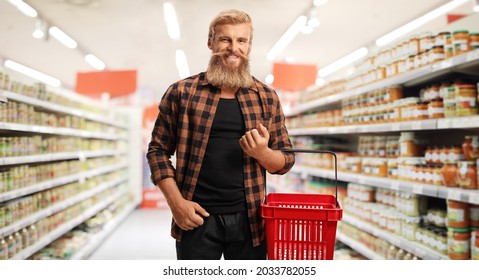 Bearded Young Guy With A Shopping Basket Inside A Supermarket