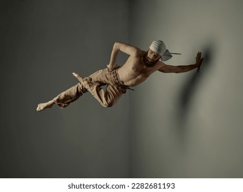 Bearded young man with strong muscular shirtless body training, doing yoga exercises, standing on one hand over studio background. Art of movement, male body aesthetics, health, sportive lifestyle - Shutterstock ID 2282681193