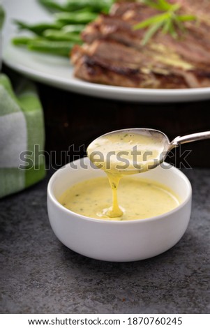 Bearnaise sauce made with tarragon in a small bowl