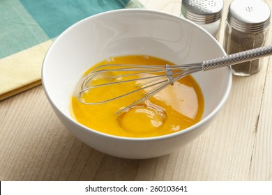  Beaten Egg Yolks In A Bowl With Whisk