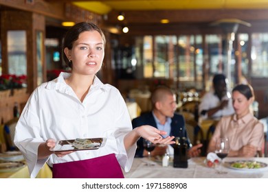 Beatiful Woman Waiter Demonstrating Her Upset With Small Tip In Restaurant