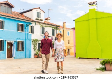 Beatiful young couple having fun while visiting Burano, Venice - Tourists travelling in Italy and sightseeing the most relevant landmarks of Venezia - Concepts about lifestyle, travel, tourism