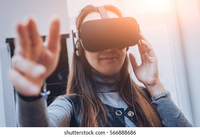 The beatyfull girl wearing virtual reality goggles at the office