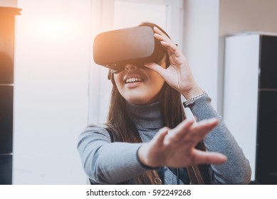 The beatyfull girl wearing virtual reality goggles at the office