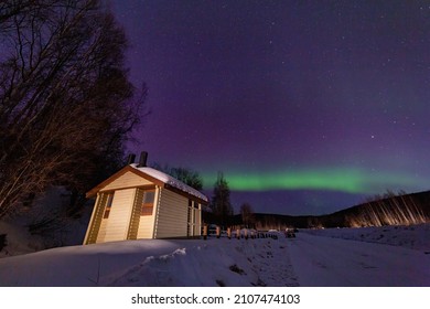 Beauitful aurora over the night sky, wooden house at Fairbanks, Alsaka