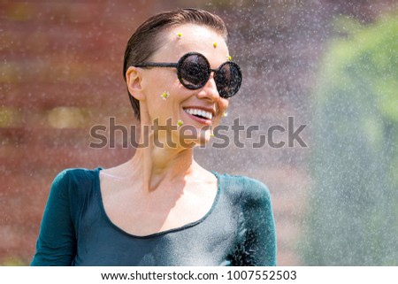 Beauitful  young woman enjoy summer vacation under summer rain