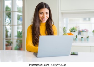 Beauitul young woman working using computer laptop concentrated and smiling