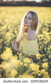 Beautfil young caucasian woman is posing in the field of raps.